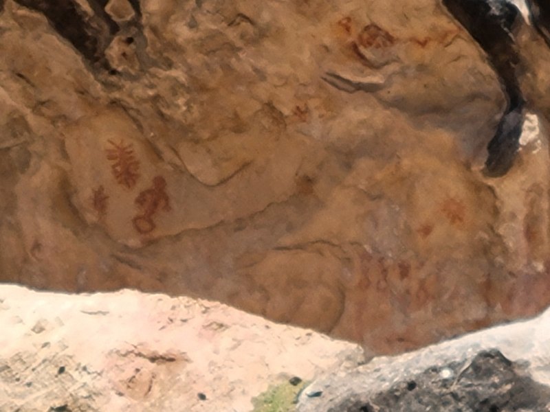Red painted figures on a sheltered rock surface west of Heber